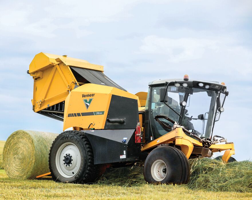 A Vermeer ZR5-1200 self-propelled baler ejects a hay bale.