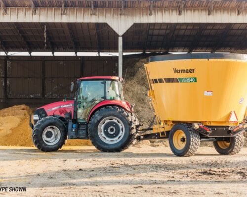 A Vermeer vertical mixer is pulled behind a tractor on an Iowa farm.