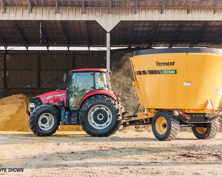 A Vermeer vertical mixer is pulled behind a tractor on an Iowa farm. 