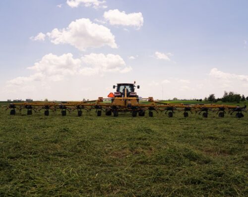 A Vermeer TE485 hay tedder in a field
